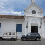 View of Andrián Balseca’s Andino car (left) parked outside of the Museo Municipal de Arte Moderno, Cuenca.