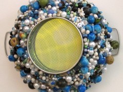 Mixed Media = Mirror, faux pearls, tagua and chonta beads, beads hand beaded on kitchen strainer 10 x 12 inches