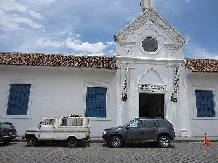 View of Andrián Balseca’s Andino car (left) parked outside of the Museo Municipal de Arte Moderno, Cuenca.