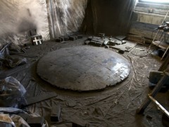 Studio view with Convex Coal Mirror (coal, 72 x 72 x 8 inches) on floor